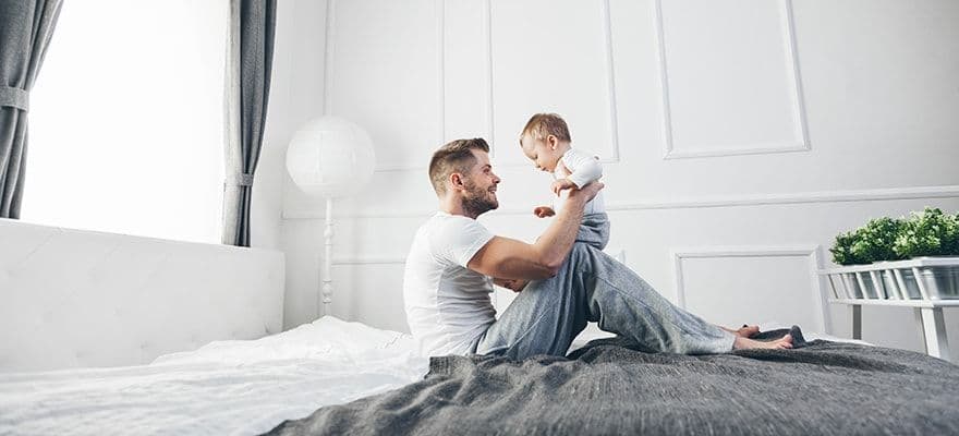 Proud Father Playing With Cute Baby Son